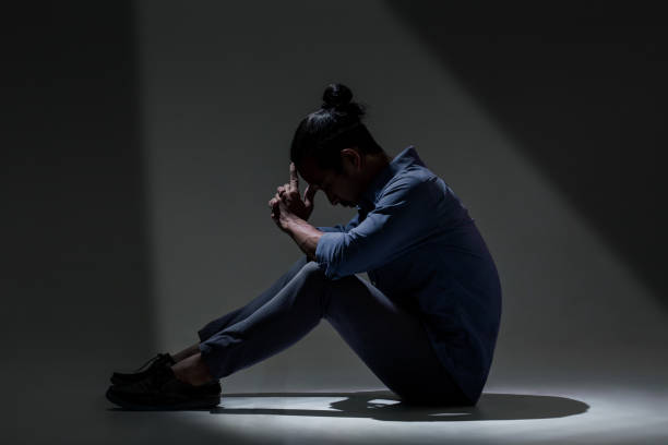 istock An Asian man is suffering from depression in darkness. 1134016802