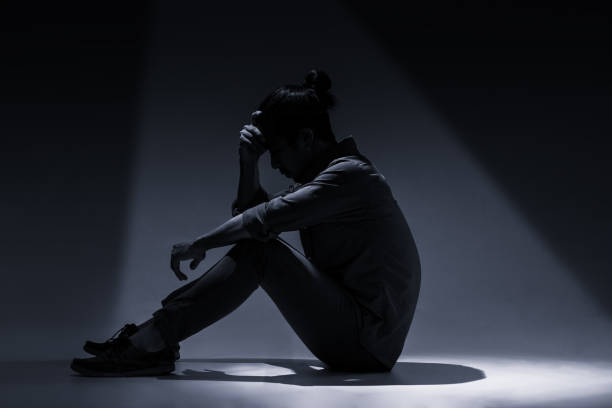 istock An Asian man is suffering from depression in darkness. 1134016880