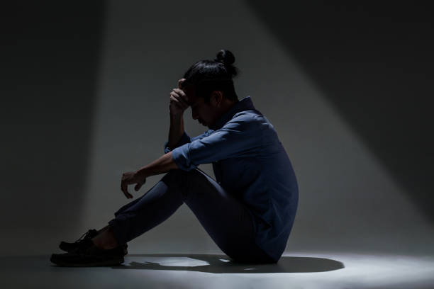 istock An Asian man is suffering from depression in darkness. 1134016881