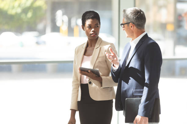 istock Business people interacting with each other in lobby 1134017562