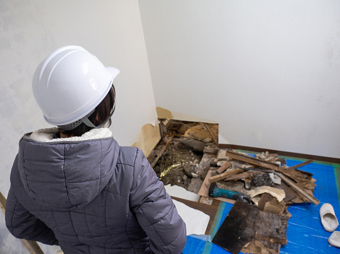 Foreman standing in front of the hole in a room.