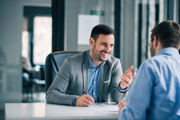 Man having a business meeting and signing a contract, recruitment or agreement. Man having a business meeting and signing a contract, recruitment or agreement. customer stock pictures, royalty-free photos & images