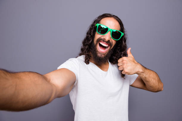 istock Self-portrait of his he nice cool trendy attractive cheerful optimistic crazy wavy-haired guy showing thumbup ad advert advertising isolated over gray violet purple pastel background 1134018822