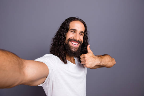 istock Self-portrait of his he nice trendy attractive cheerful cheery optimistic wavy-haired guy showing thumbup decision advert ad isolated over gray violet purple pastel background 1134019974
