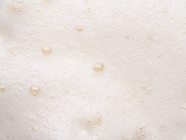 Beer or cappucino foam with bubbles texture Foam texture extreme close up as background. Beer or cappucino foam with bubbles macro shoot. Copy space for text. frothy drink stock pictures, royalty-free photos & images