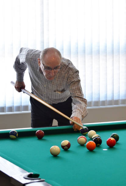 Senior Man Shooting a Game of Pool