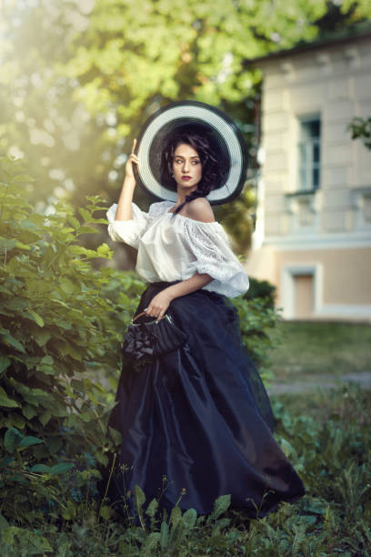 istock Beautiful brunette in a big black and white hat 1134020548