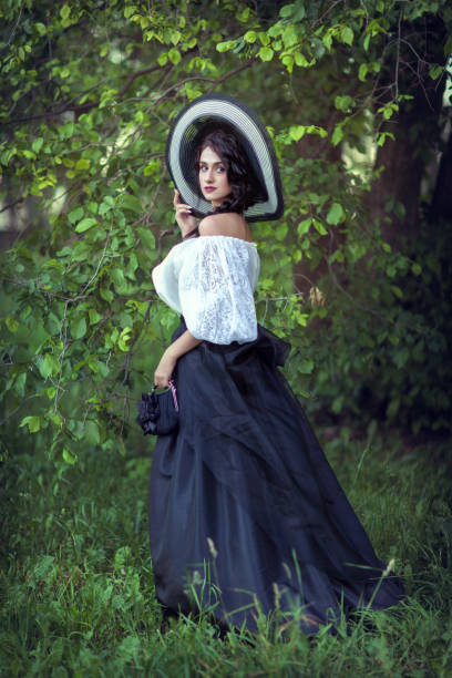 istock Beautiful brunette in a big black and white hat 1134020562