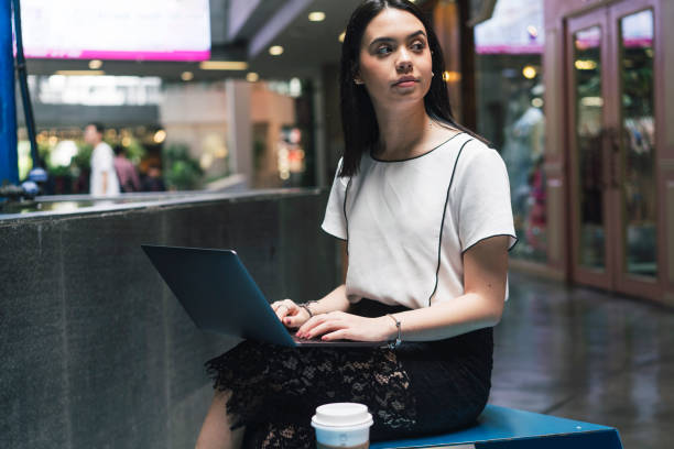 young adult businesswoman working with a laptop in the city - siam square imagens e fotografias de stock