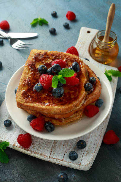 istock French cinnamon toast with blueberries, raspberries, maple syrup and coffee. morning breakfast 1134022090