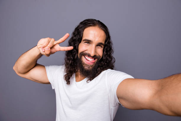 istock Self-portrait of his he nice cool attractive cheerful cheery optimistic wavy-haired guy showing v-sign lifestyle isolated over gray violet purple pastel background 1134022094