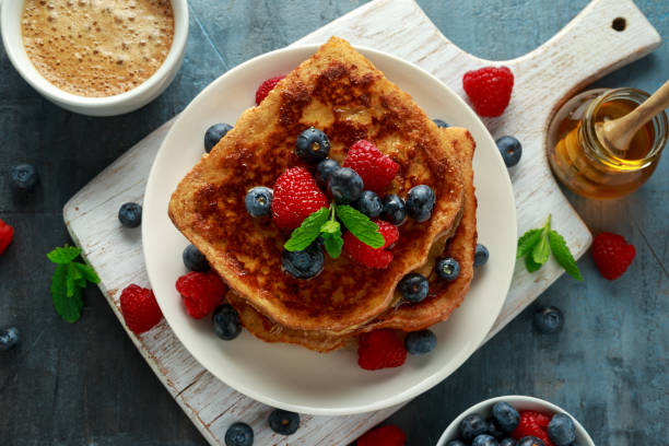istock French cinnamon toast with blueberries, raspberries, maple syrup and coffee. morning breakfast 1134022096