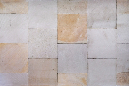 Close up wall cladding of multi colored sandstone tile backgrounds