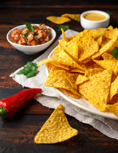 istock Tortilla nachos chips with cheese sauce, guacamole and tomatoes salsa dip. lime. chilli pepper. 1134022627