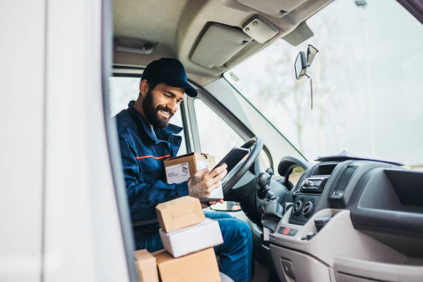 istock Delivery man with a parcel box in the car. 1134023894