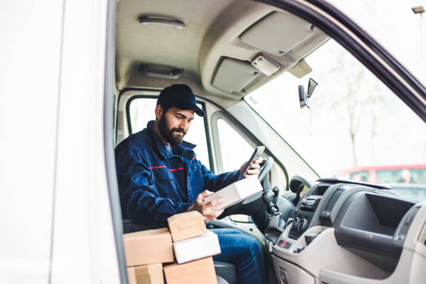 istock Delivery man with a parcel box in the car. 1134023907