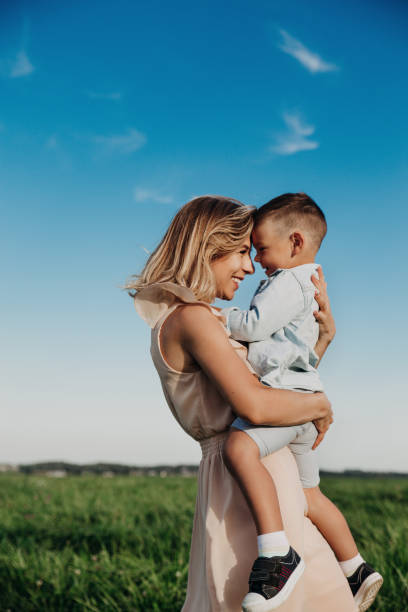 Young mother and her adorable little son outdoor stock photo