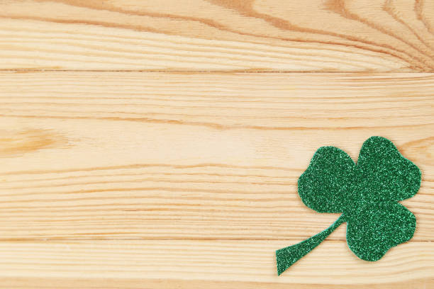 istock Green clover leaf on brown wooden table 1134026980