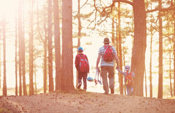 istock Father and boys going camping with tent in nature 1134027763