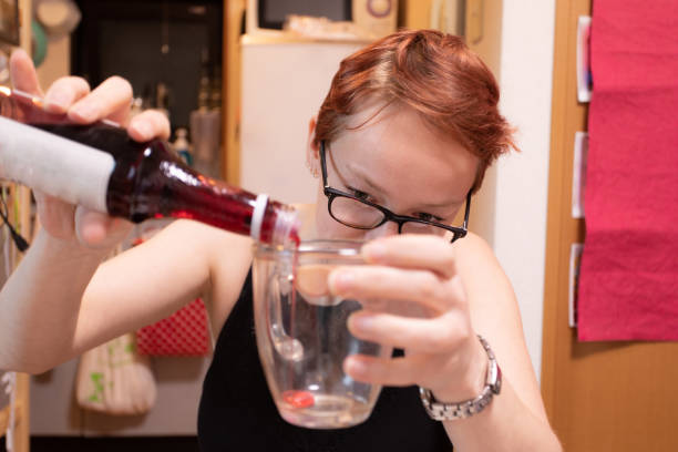 Caucasian woman pouring syrup to a cup