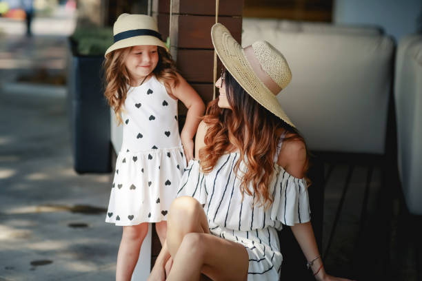 Happy two parent family with two daughters enjoying sunny summer day