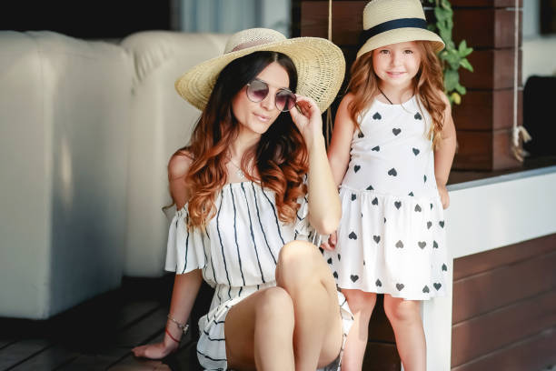 istock Mother and daughter in a hat during the summer walks. 1134028748