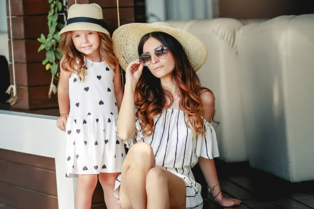 istock Mother and daughter in a hat during the summer walks. 1134028784