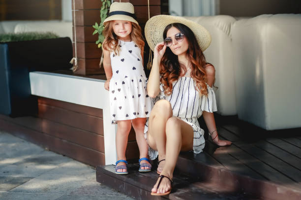 istock Mother and daughter in a hat during the summer walks. 1134028829
