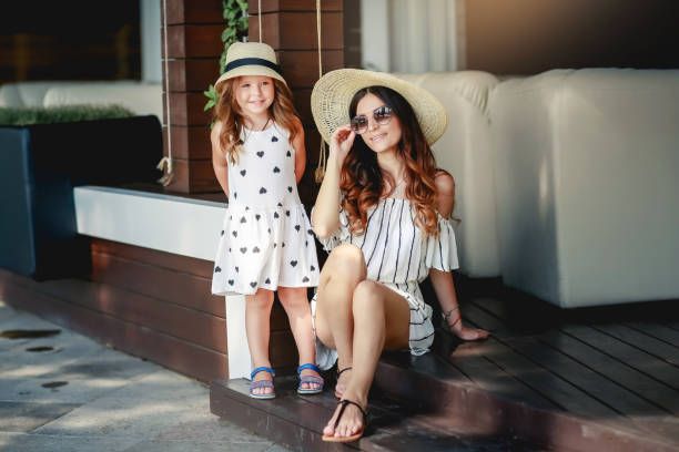 istock Mother and daughter in a hat during the summer walks. 1134028932