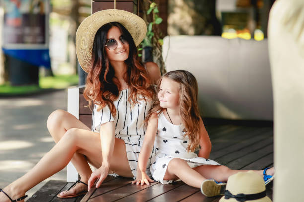 Mother and daughter in a hat during the summer walks.