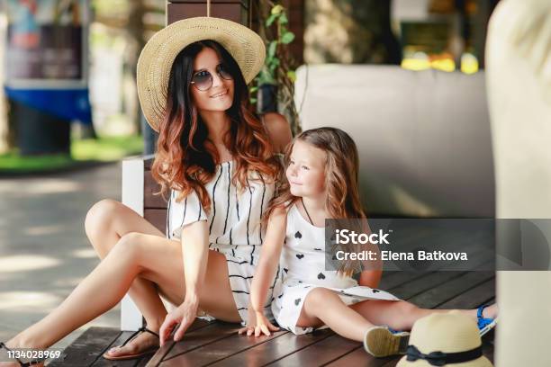 Mother And Daughter In A Hat During The Summer Walks Stock Photo - Download Image Now