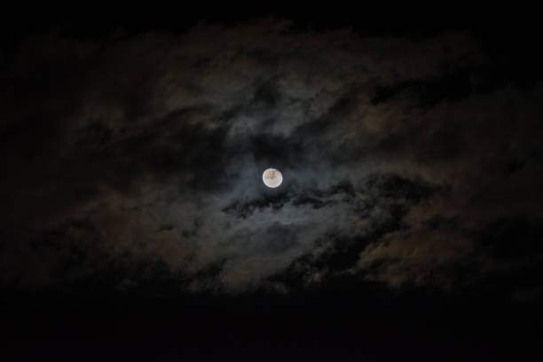 istock Moon at the night with clouds surrounding it 1134029515