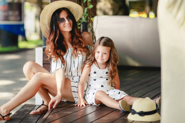 istock Mother and daughter in a hat during the summer walks. 1134029562