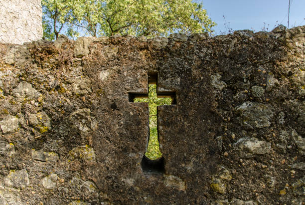 Looking through a cross carved into a stone wall at the Convent of Christ in Tomar, Portugal.