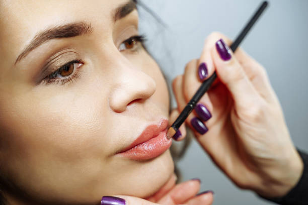 istock Beautiful model girl applying lipgloss. Lipstick. Professional Make-up. 1134031727