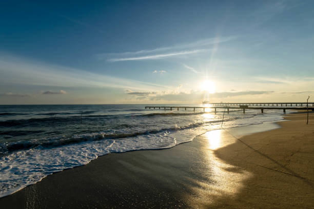 istock Old bridge  into the sea at sunrise time. 1134033449