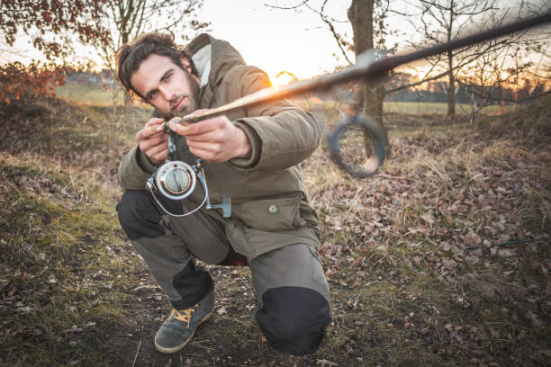 istock Fisherman checking a fishing rod 1134033457