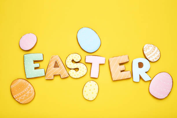 istock Word Easter by gingerbread cookies on yellow background 1134034905