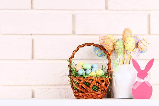 istock Easter colorful eggs and paper rabbit on brick wall background 1134035284