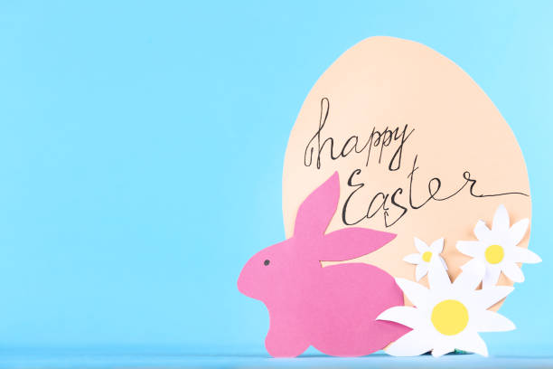 istock Paper rabbit with flowers and text Happy Easter on blue background 1134036613