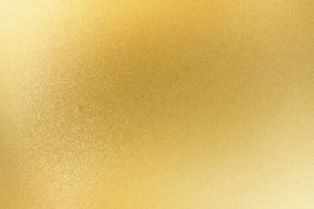 Photo of Shiny light gold metallic sheet, abstract texture background