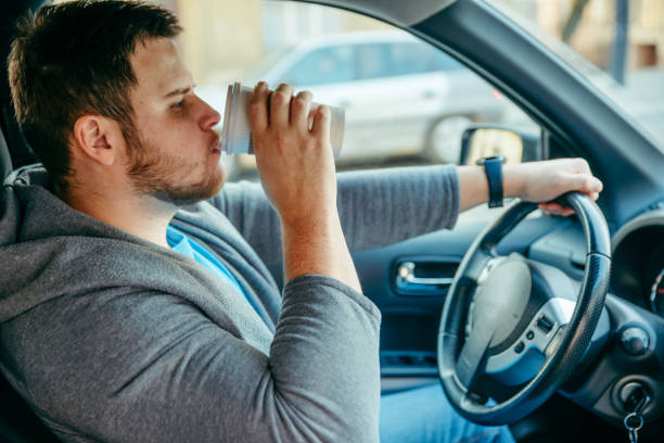 istock man driving car and drinking coffee 1134036923