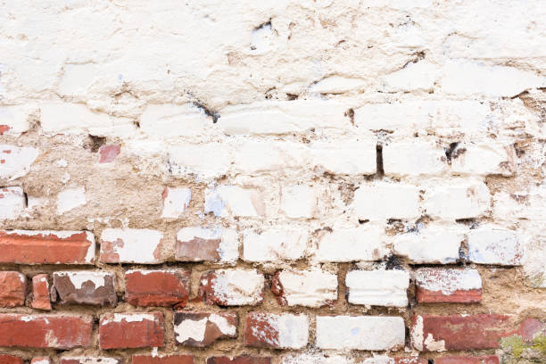 A weathered old white brick wall A weathered old white brick wall as a background gebrochen stock pictures, royalty-free photos & images