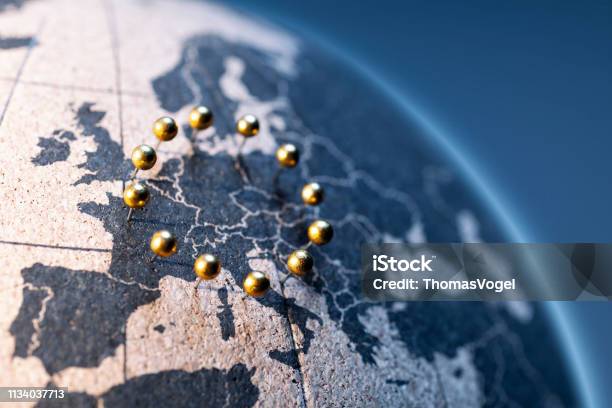 European Union Golden Pins On Cork Board Globe Stock Photo - Download Image Now - European Union, Europe, European Union Flag