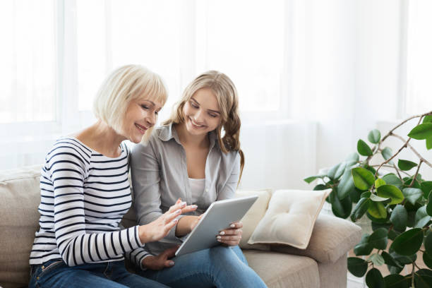 istock Senior mother and daughter browsing internet on tablet 1134039255