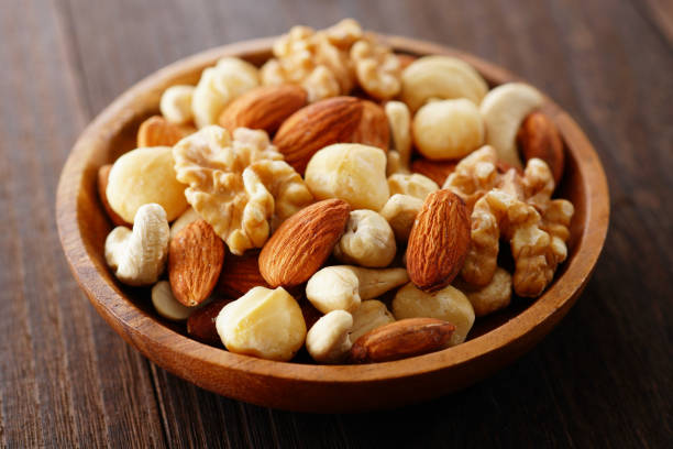 istock Mixed nuts in a wooden plate. 1134039682