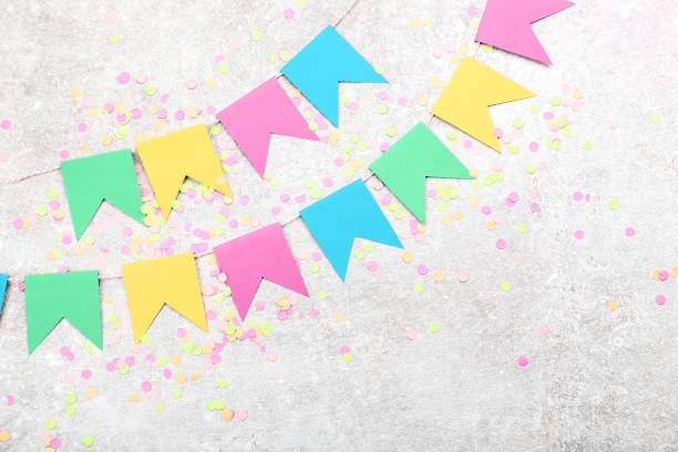istock Colorful confetti and paper flags on gray background 1134039730