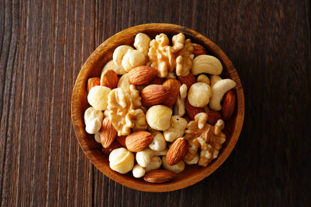 istock Mixed nuts in a wooden plate. 1134039739