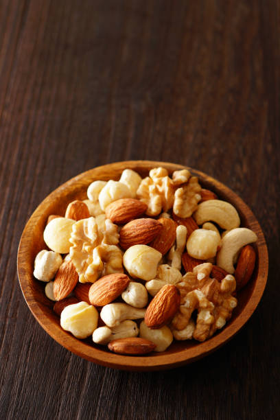 istock Mixed nuts in a wooden plate. 1134039845