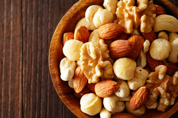 istock Mixed nuts in a wooden plate. 1134040048